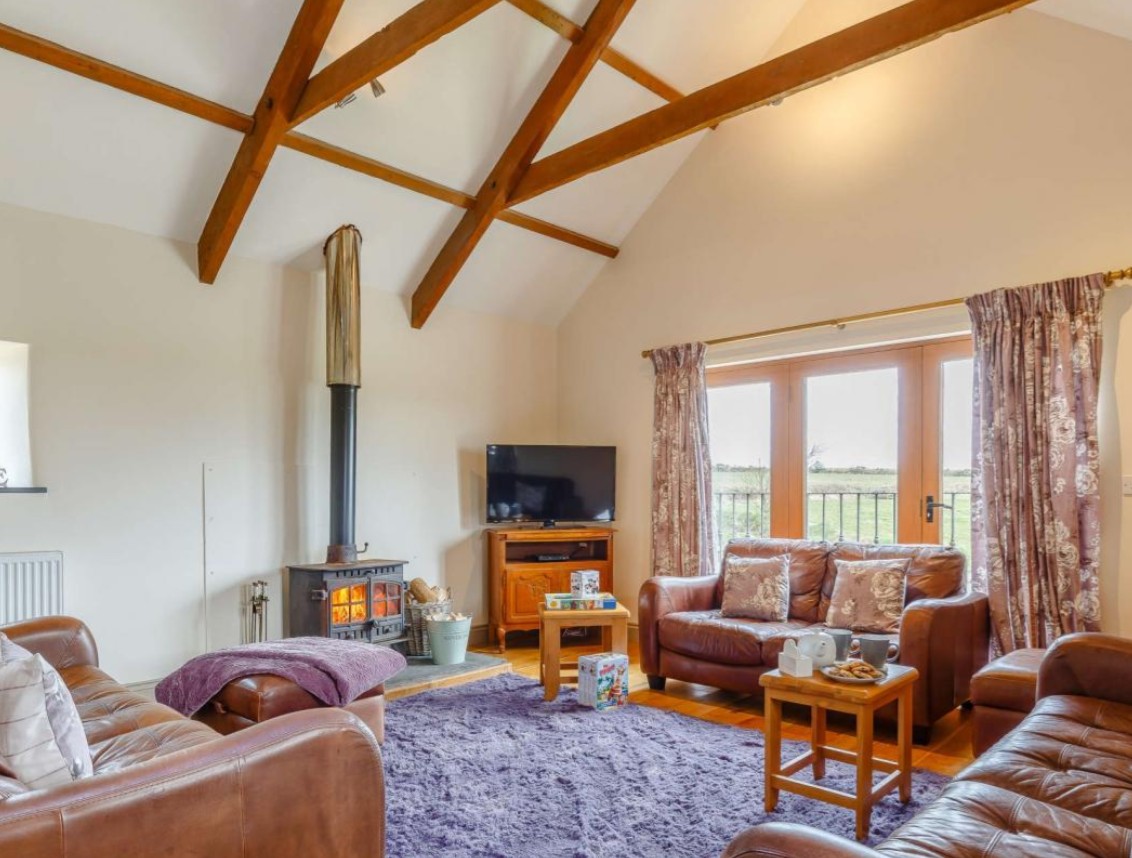 Cosy cottage interior with exposed beams...